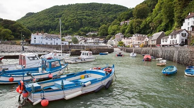 Boats in Lynmouth Harbour with the village in the background